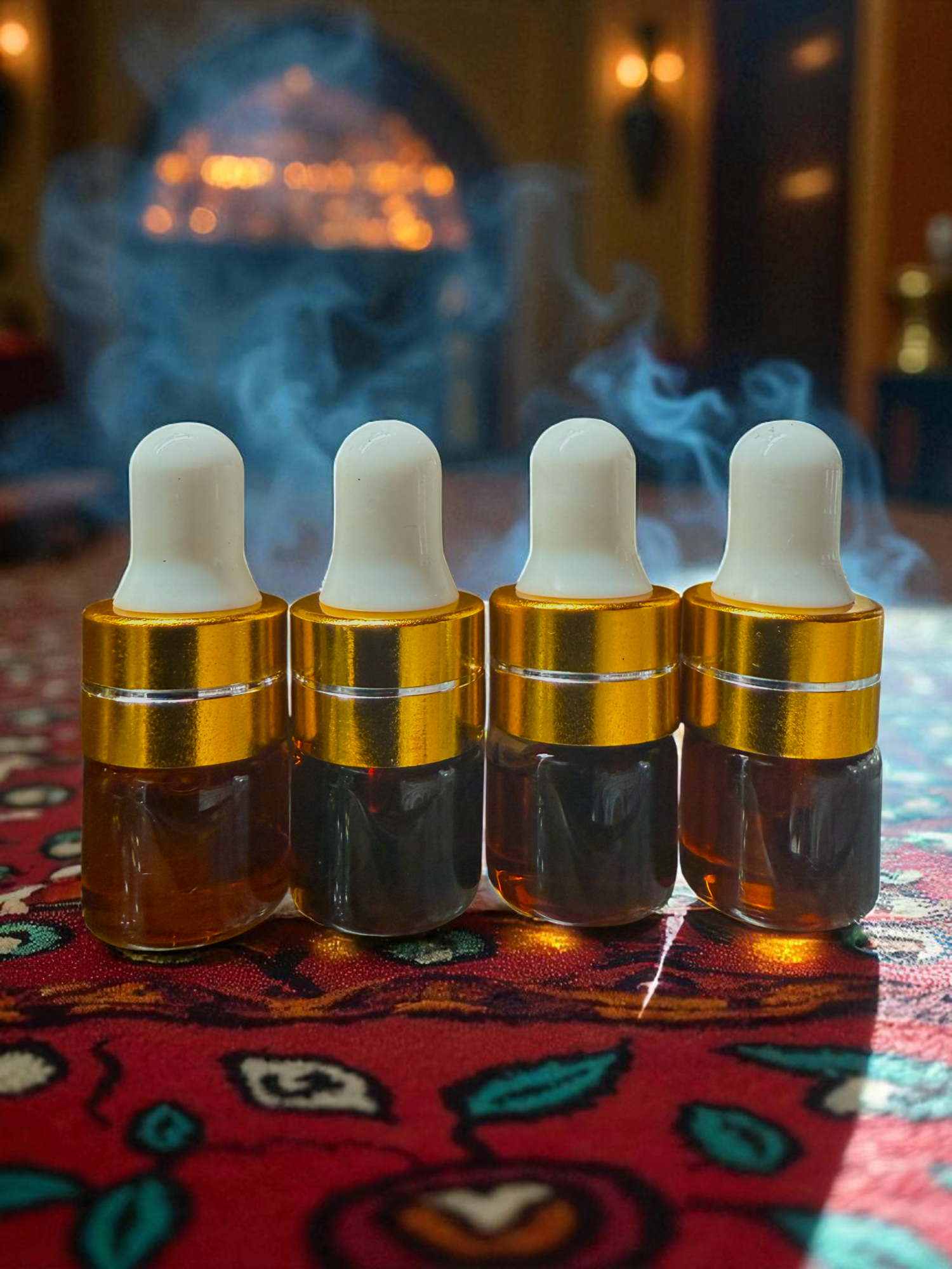 Four small glass bottles with gold caps