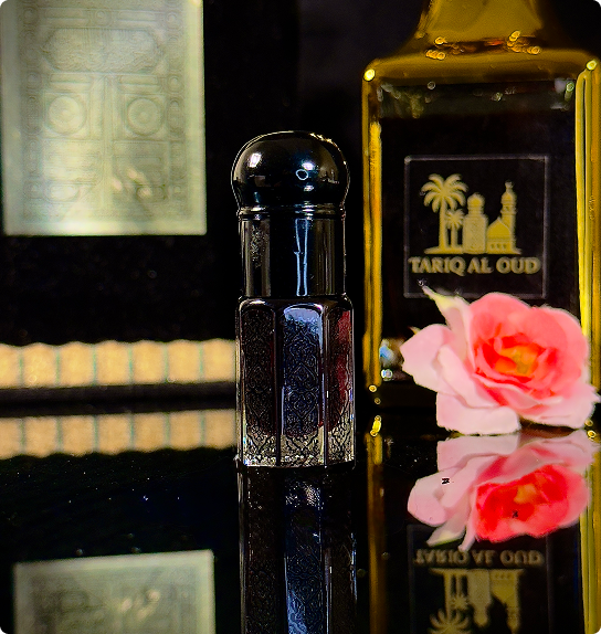 Black perfume bottle with a pink flower